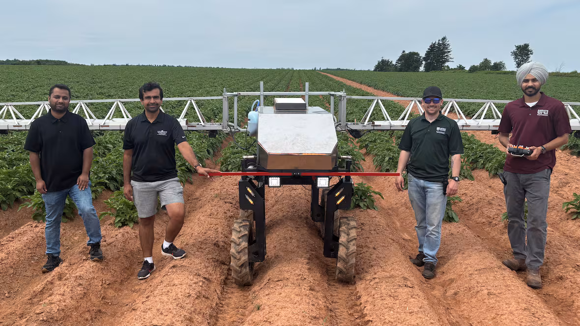Agriscout robot in a potato field with team members