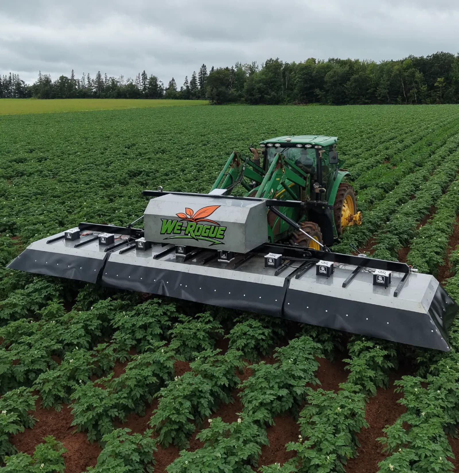 The We-Rogue camera boom mounted on a tractor, working over potato rows