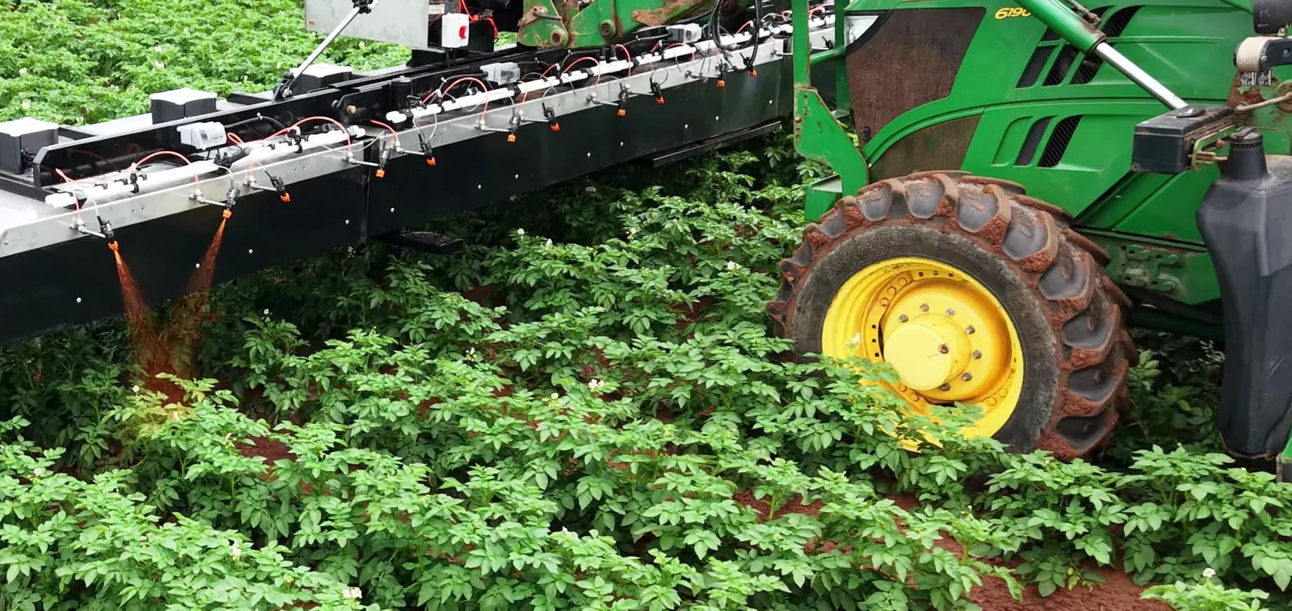 We-Rogue boom and tractor working through potato rows